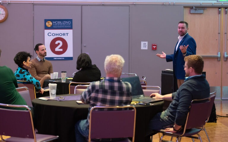 Attendees at a Recharge Symposium at a round table discussion.