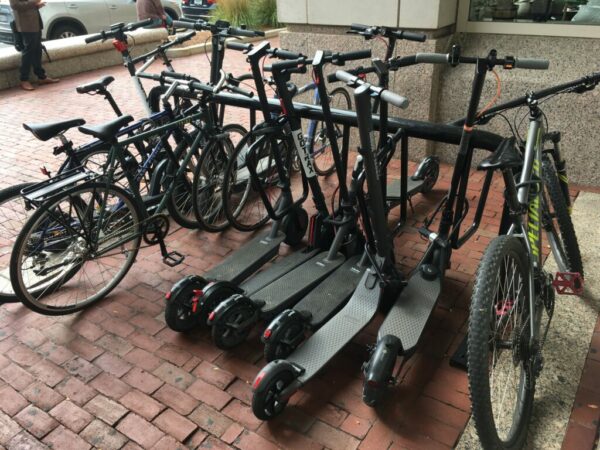 Bikes and Scooters line up at bike rack